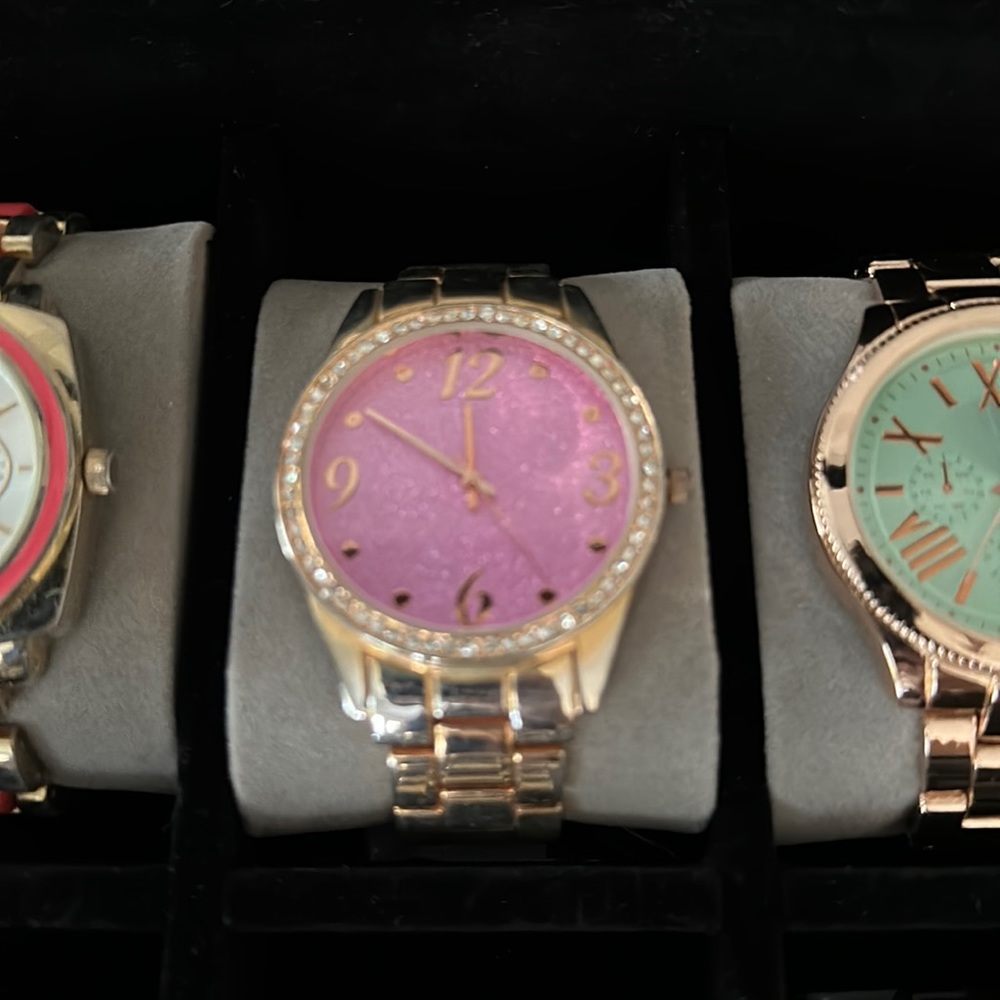 Gold watch with pink glitter background
